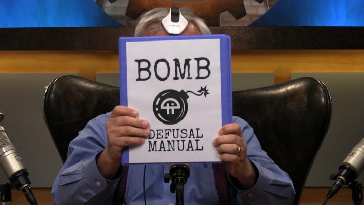 Leo shows off the bomb defusal manual that will assist him in the game.