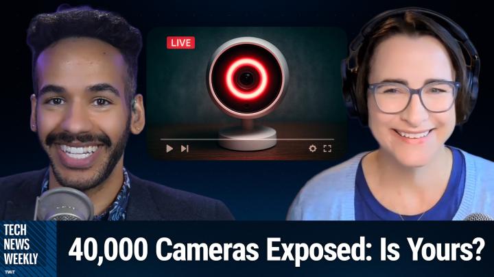 A wide-eyed baby monitor camera glowing red, angled as if it’s looking directly at the viewer.